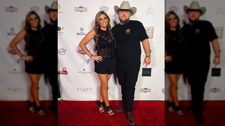 Brandi Passante (L) poses wearing a sheer black dress next to a male friend (R)