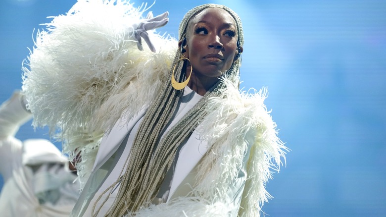 Brandy wearing all white with very long light blond braids