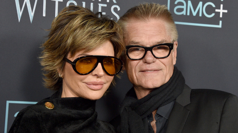 Lisa Rinna wears sunglasses while posing next to husband Harry Hamlin on the red carpet