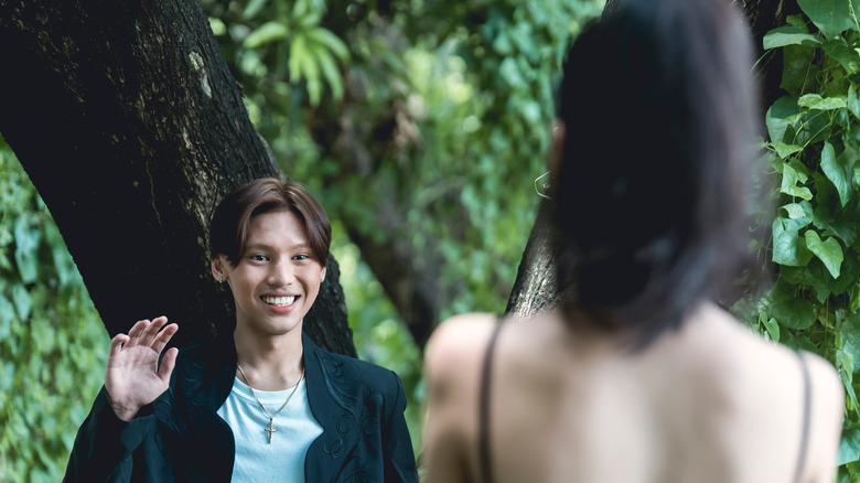 man waving at woman