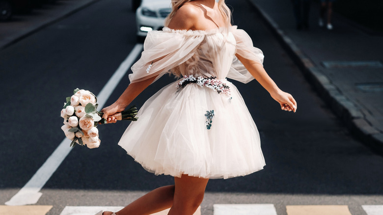 Woman walking in short white dress