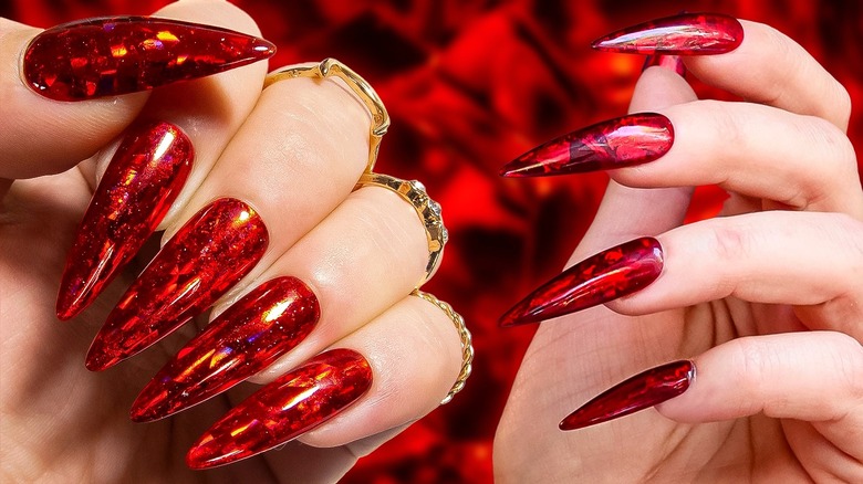 Red nails with golden rings