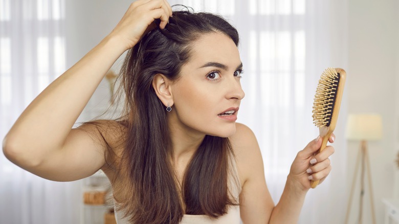 Woman holding hairbrush