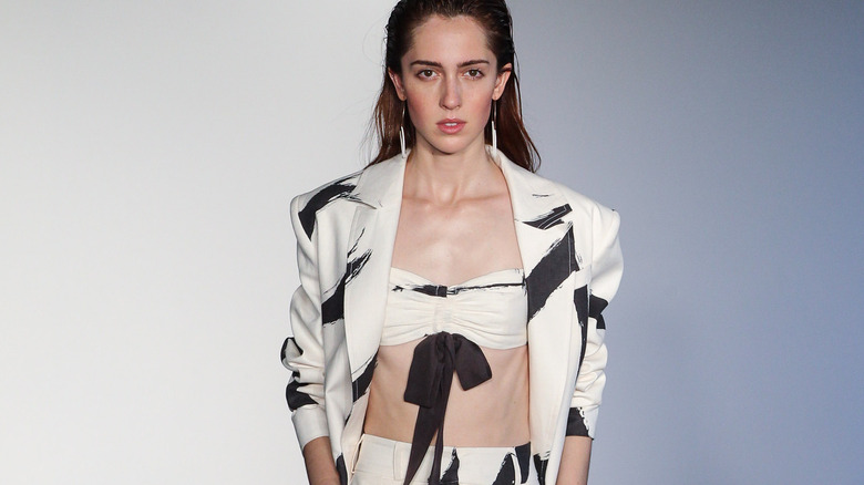 Model on runway with brushstroke print suit