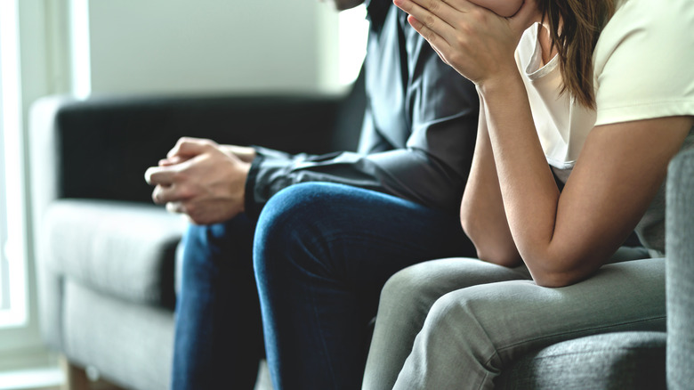 Couple on sofa is upset