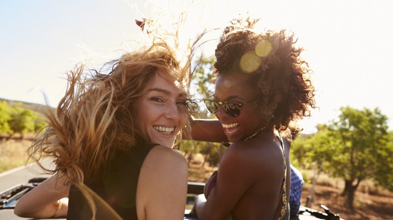 Smiling women in convertible car