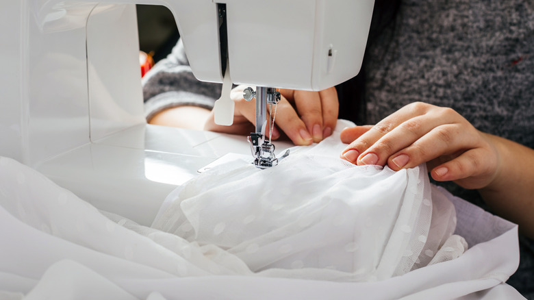 Woman altering wedding veil