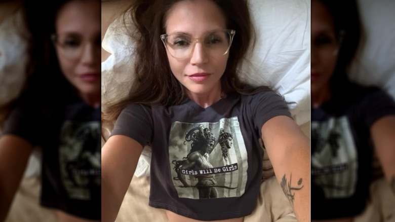 Charisma Carpenter taking a selfie in bed