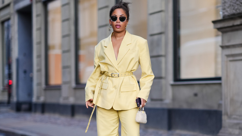 Woman wearing yellow pantsuit blazer