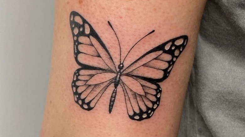 Microrealistic butterfly couple tattoo on the upper