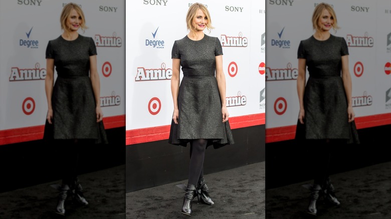 Cameron Diaz in a gray winter dress, tights, and shiny boots