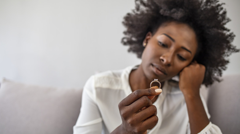 woman looking at engagement ring