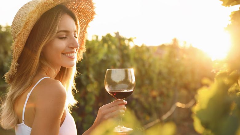 Woman gazes at red wine