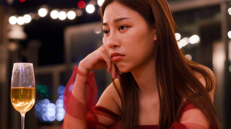 Unhappy woman alone in bar