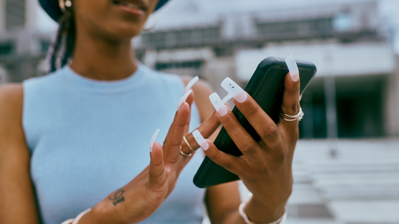 Woman with long acrylic nails