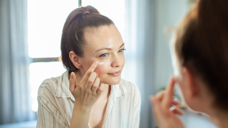 Woman applying eye cream