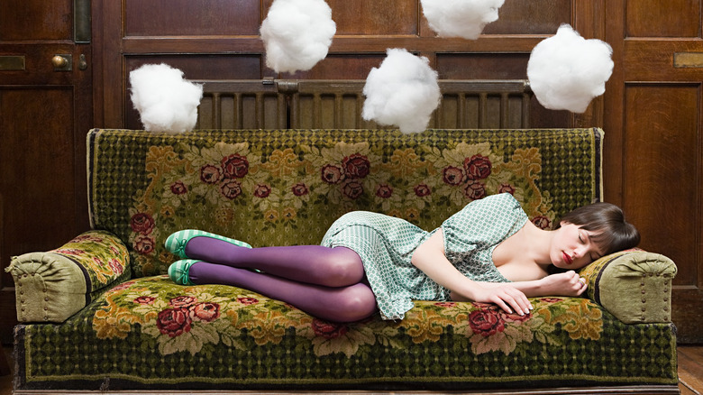 A woman dreaming on a couch