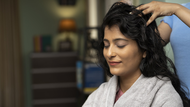 Woman having scalp massage