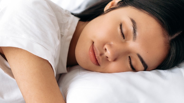 Asian female sleeps on her side