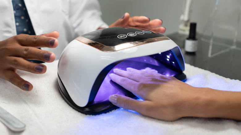 Gel nails being cured in a UV lamp