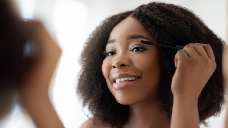 woman applying mascara