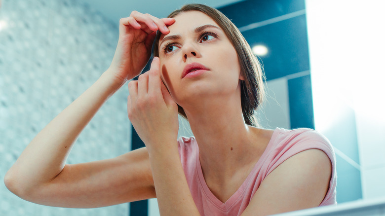 woman looking at eyebrows