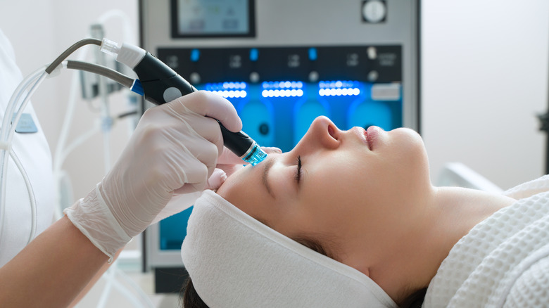 Woman receiving laser treatment in clinic