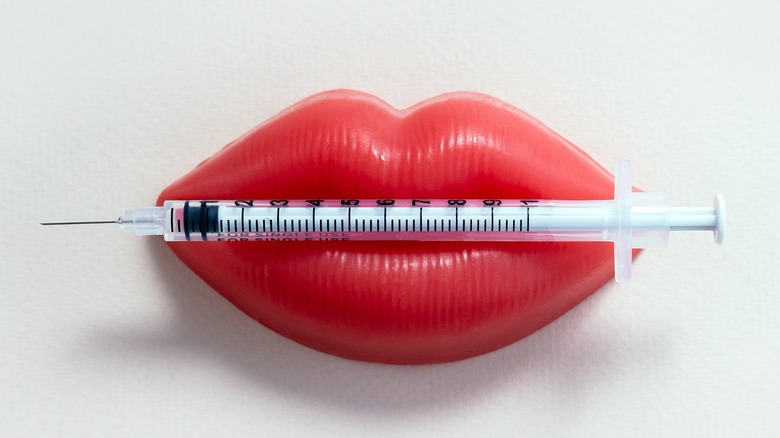 Plastic lips holding needle