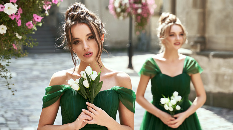 Two bridesmaids in green dresses