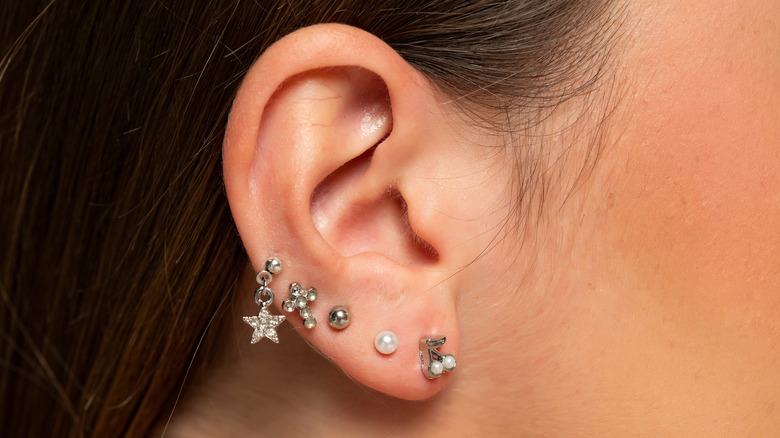 An ear with multiple piercings