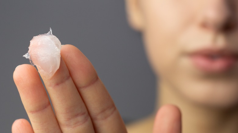 Woman holding up petroleum jelly