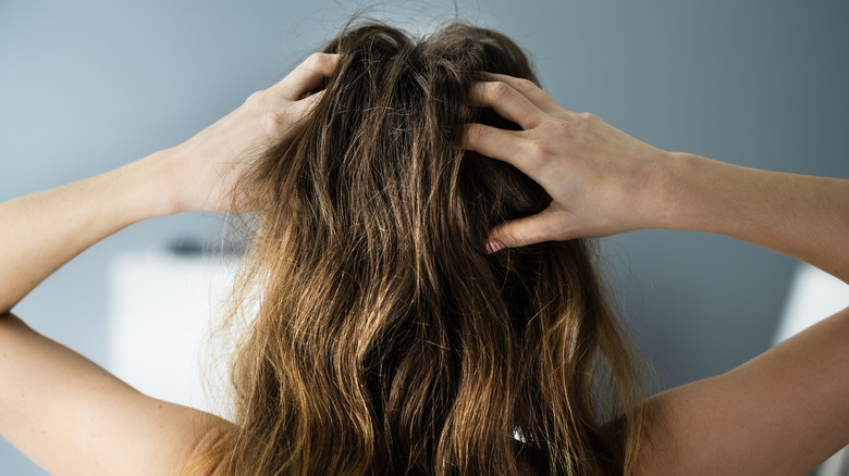 woman touching her hair