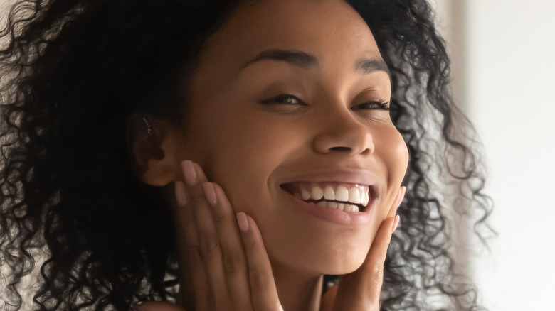 Woman touching her face