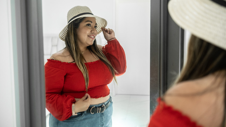 woman trying on hat