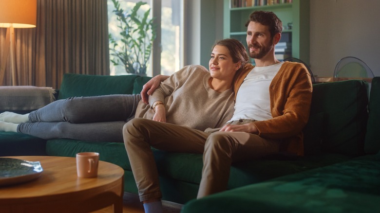 Couple cuddling on couch