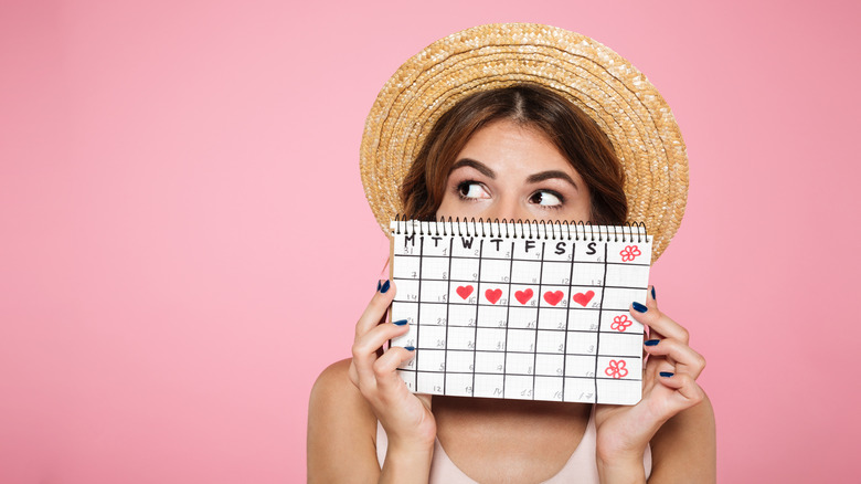 Woman holding up calendar