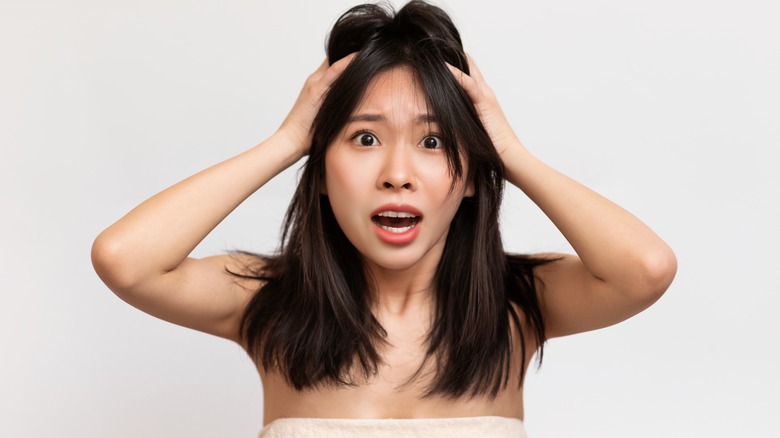 Woman with hands in hair