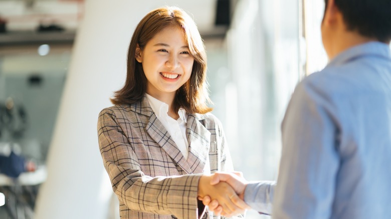 Woman shaking man's hand