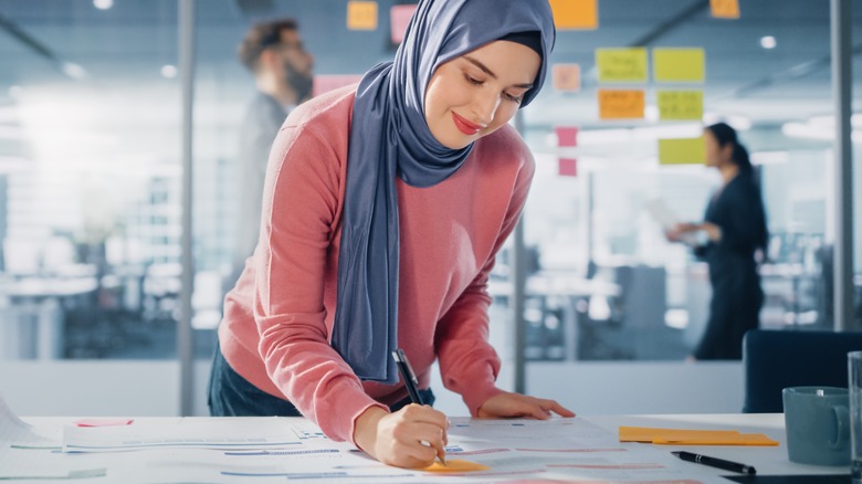 Smiling woman in headscarf at work