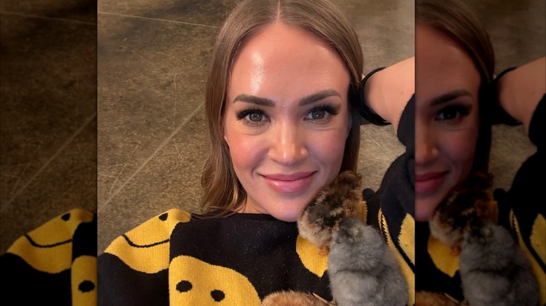 Carrie Underwood with a happy face sweater