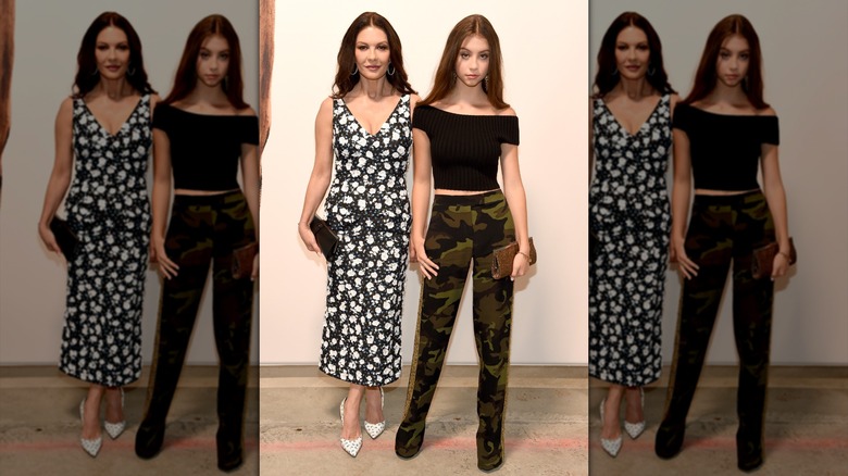 Carys Douglas wearing camo pants and a black top with Catherine Zeta Jones