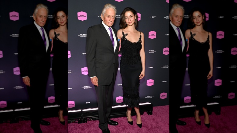 Carys Douglas wearing a black dress with her dad Michael Douglas