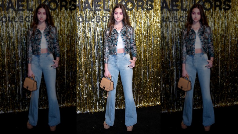 Carys Douglas wearing pink eyeshadow and a snakeskin jacket at the Michael Kors show
