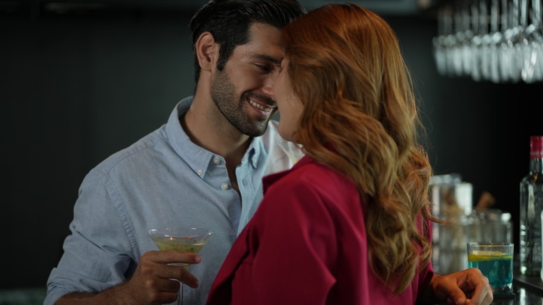 couple flirting at bar