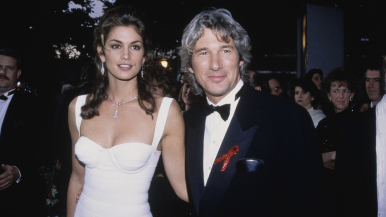 Cindy Crawford in a white dress and Richard Gere wearing a tuxedo in 1993 at an event.