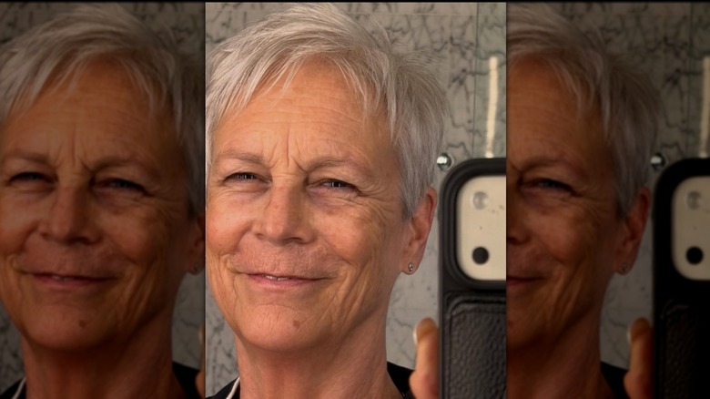 Jamie Lee Curtis smiling in a mirror selfie with no makeup.