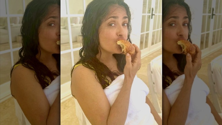 Salma Hayek enjoying a pastry without makeup