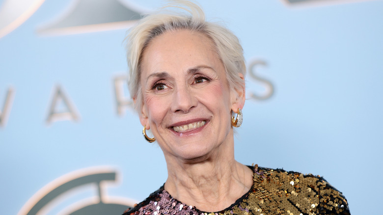 Laurie Metcalf smiling on the red carpet wearing a sequined gown and a gray pixie cut.