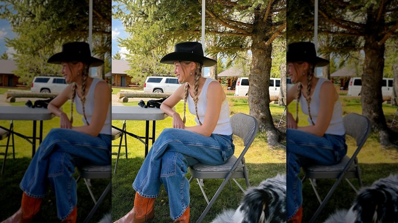 Gigi Hadid wearing jeans, cowboy boots, a cowboy hat, and a tank