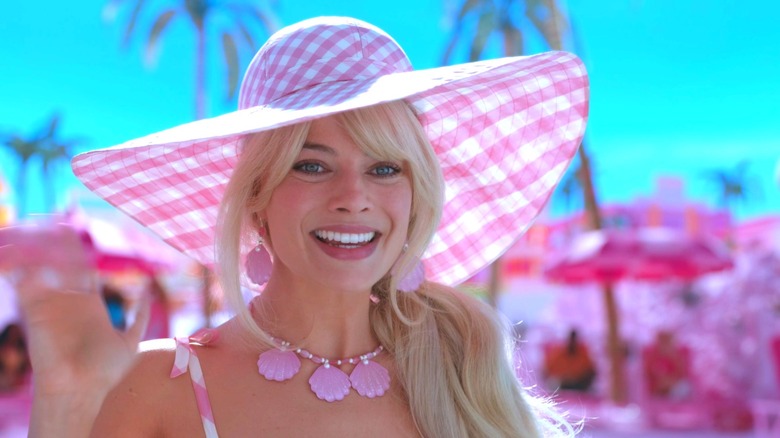 Margot Robbie as Barbie wearing a large hat